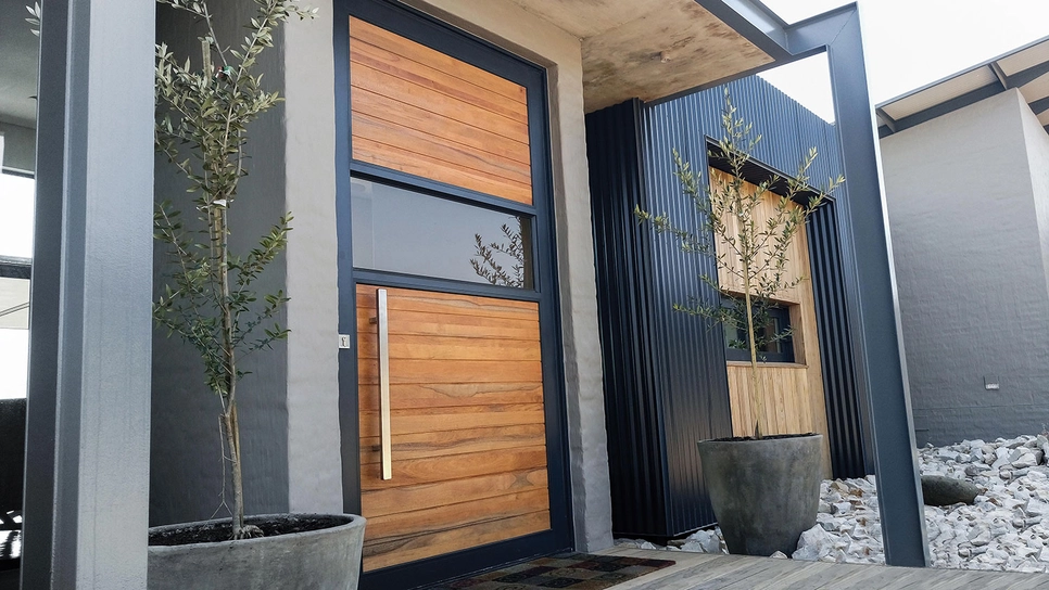 Moderna ulazna vrata u stan u kombinaciji drva, stakla i aluminija.