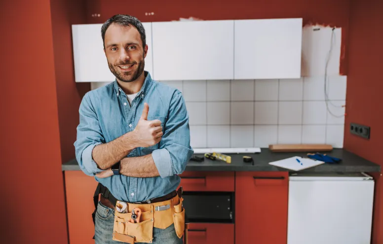 Zadovoljan stolar u kuhinji koju je baš izradio.