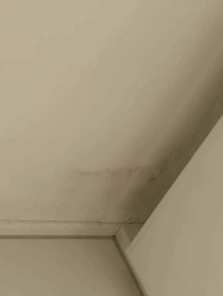 Visible water stain on ceiling corner indicating potential leak or moisture issue.